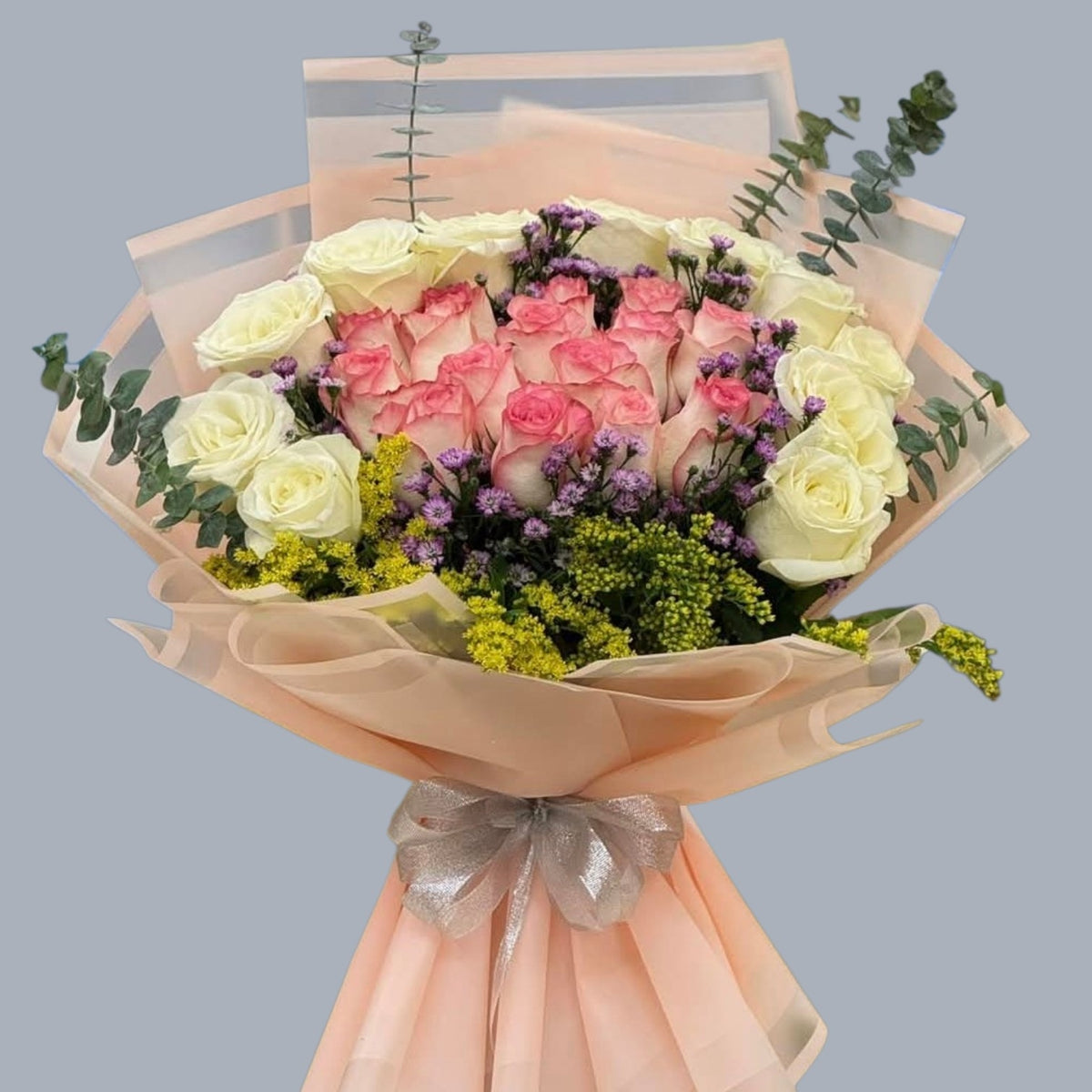 Luxury bouquet of white and pink roses with limonium and eucalyptus in beige wrap