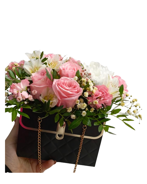 Pink roses and white alstroemeria in quilted black handbag with gold chain